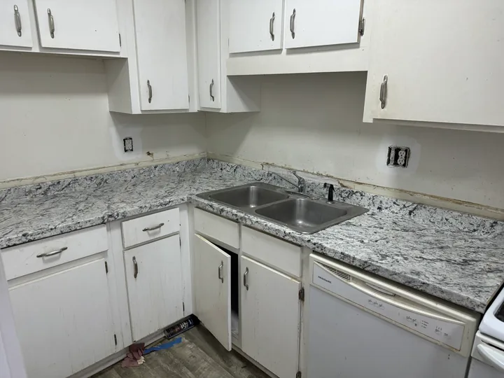 White kitchen cabinets, granite counters and dark drawer pulls