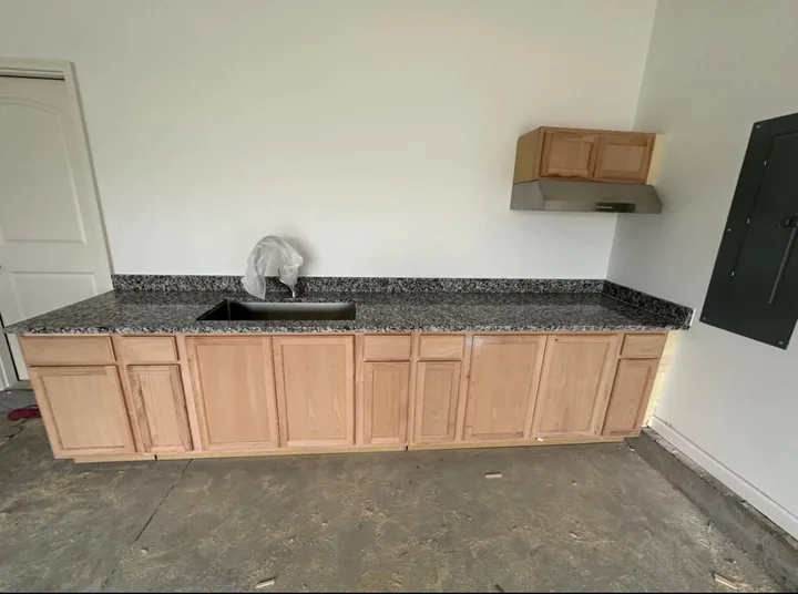 Wood kitchen cabinets and light countertops beneath wall cabinets