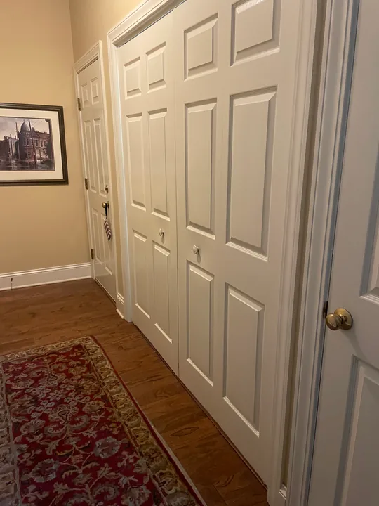 Wood flooring meeting white interior doors and trim