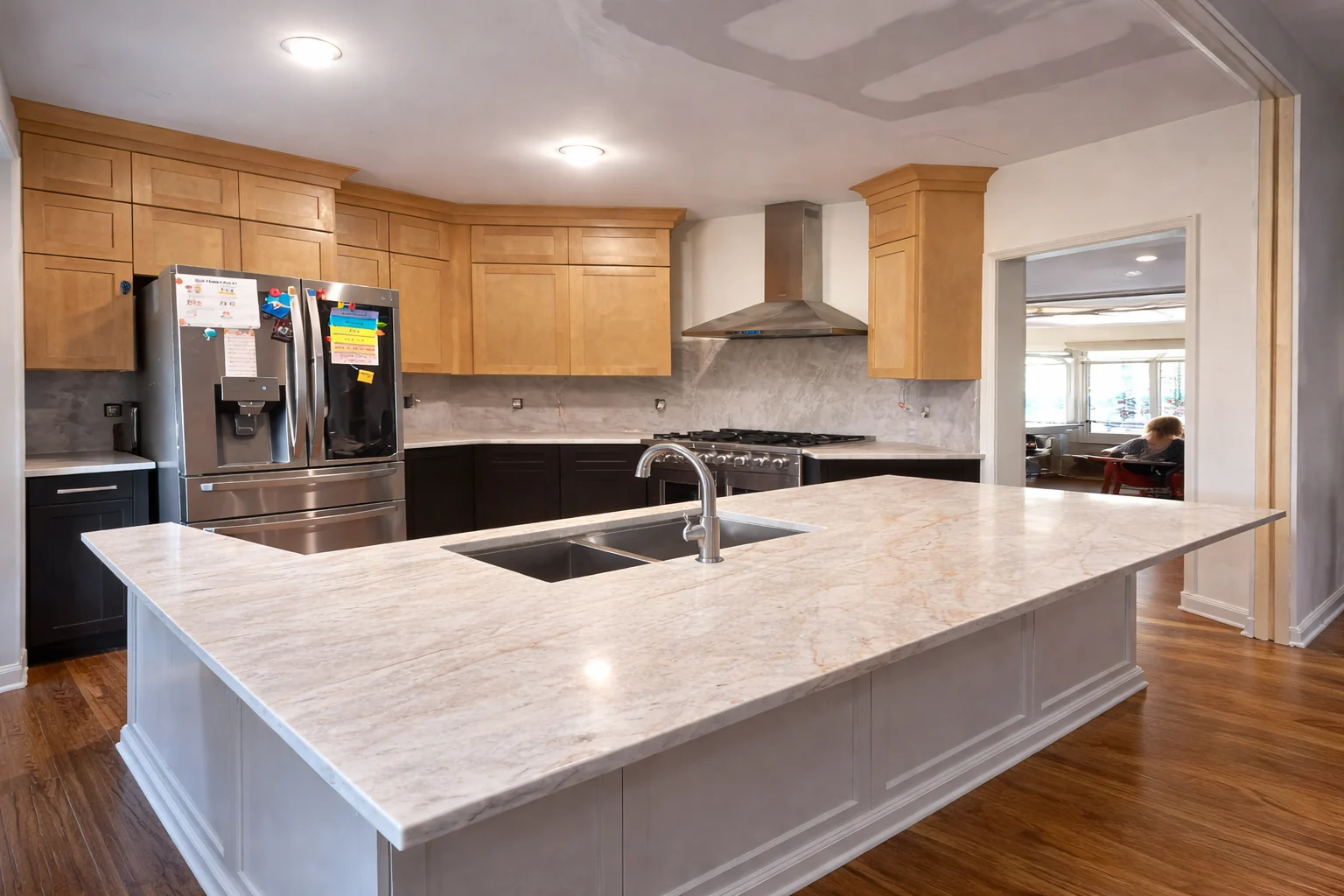 Wood kitchen cabinetry with a broad light island countertop