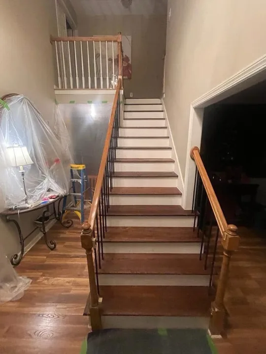 Wood staircase with painted risers and white balusters
