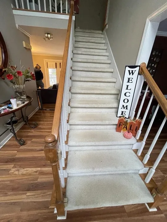 Wood staircase with painted risers and white balusters